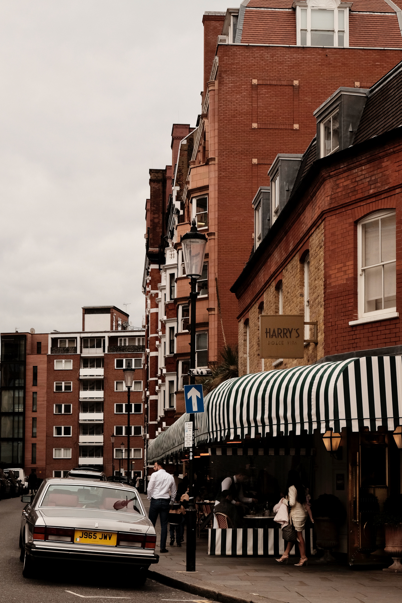 Red and white striped tarp covers outside diners of Harry's Dolce Vita