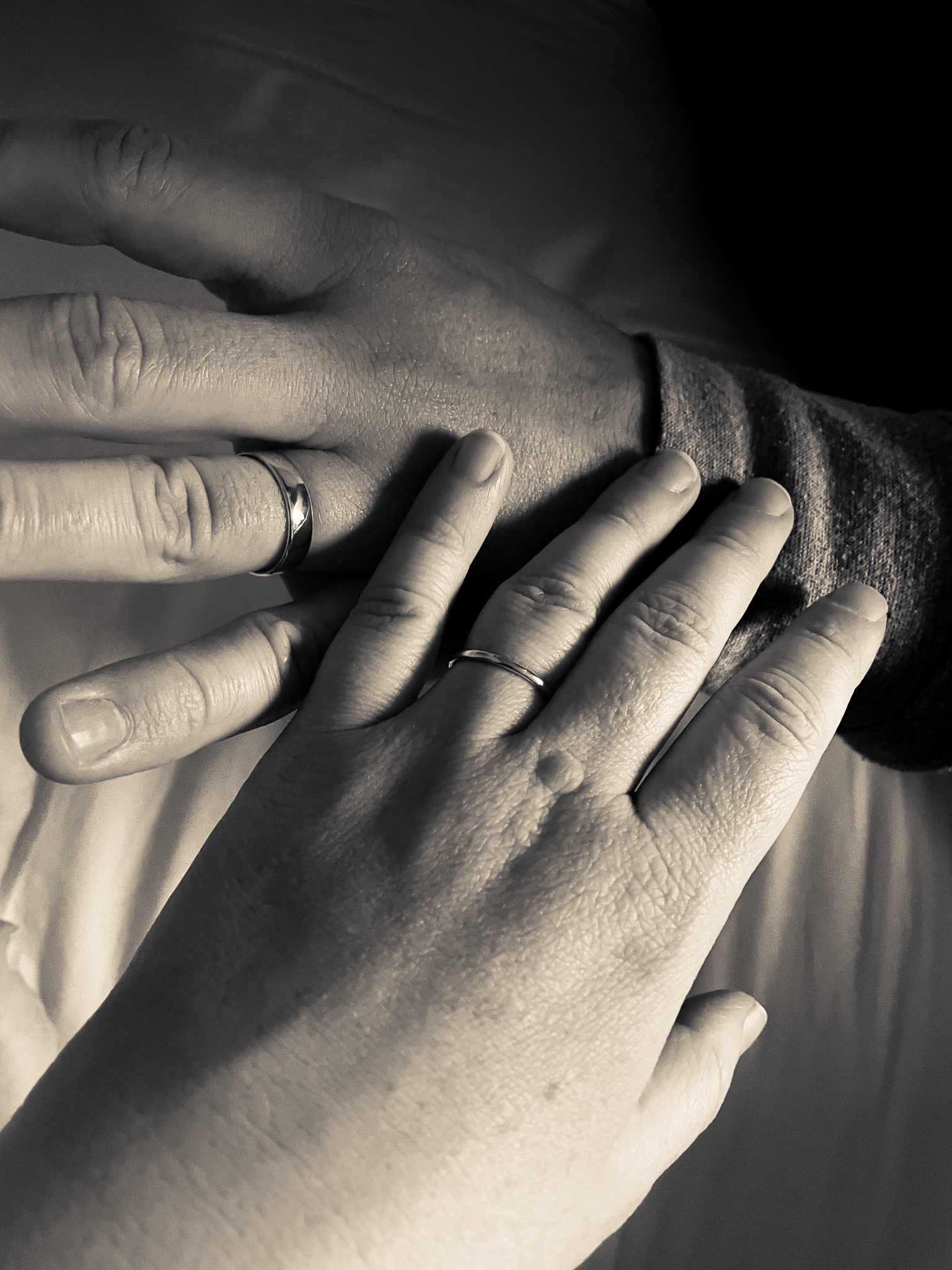 Hands touching with new wedding rings illustrated a renewed commitment to each other