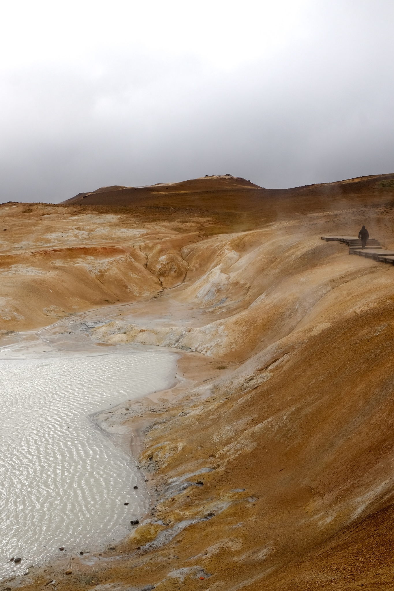 Geothermal mountain with a steamy hot white milky lake