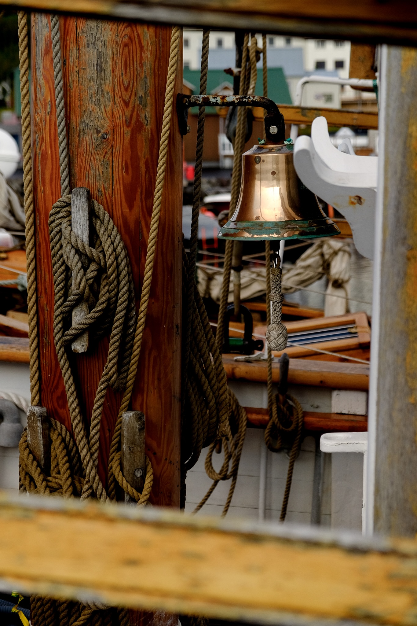 Weathered rope tied to the wooden mast of a ship