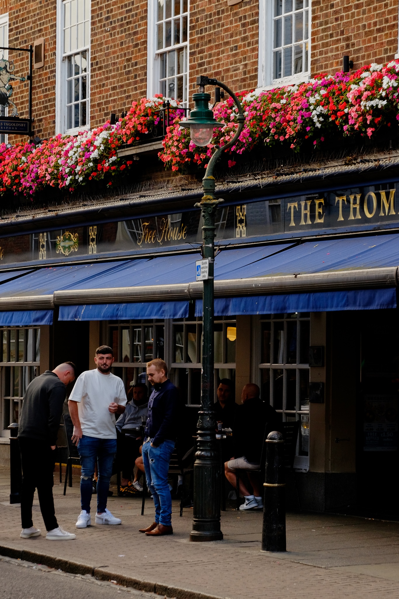 Three lads having a smoke just outside The Thomas Free House pub