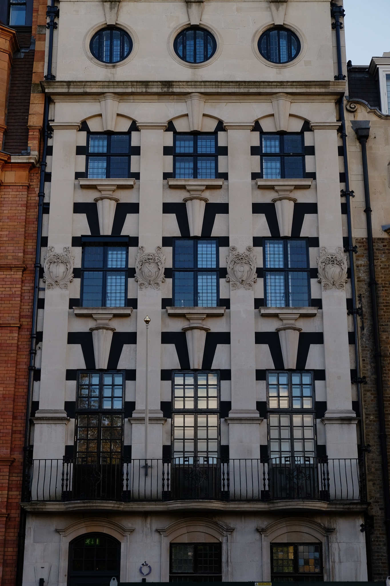 White concrete with black trim patterned building head on